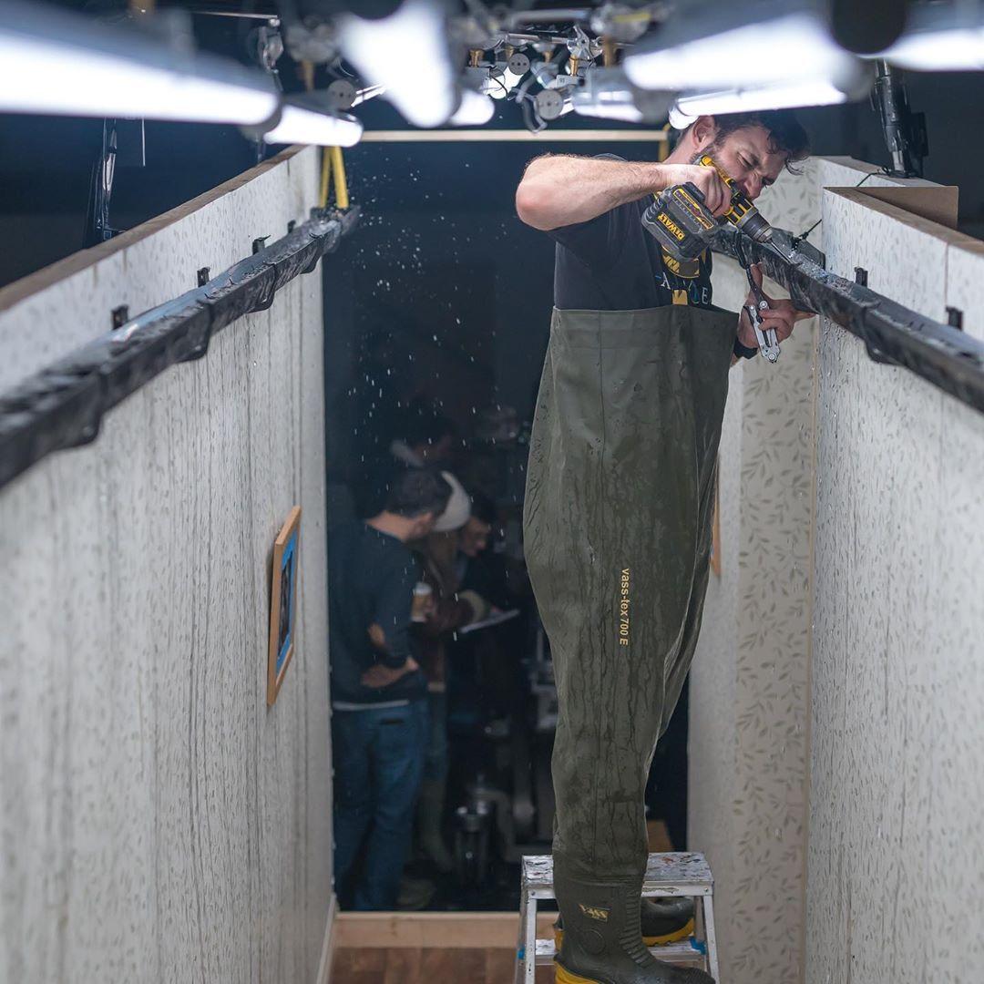 a man standing in a room holding a gun