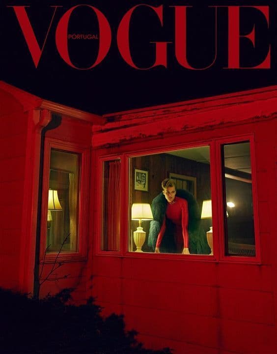 a man and a woman standing outside of a red house