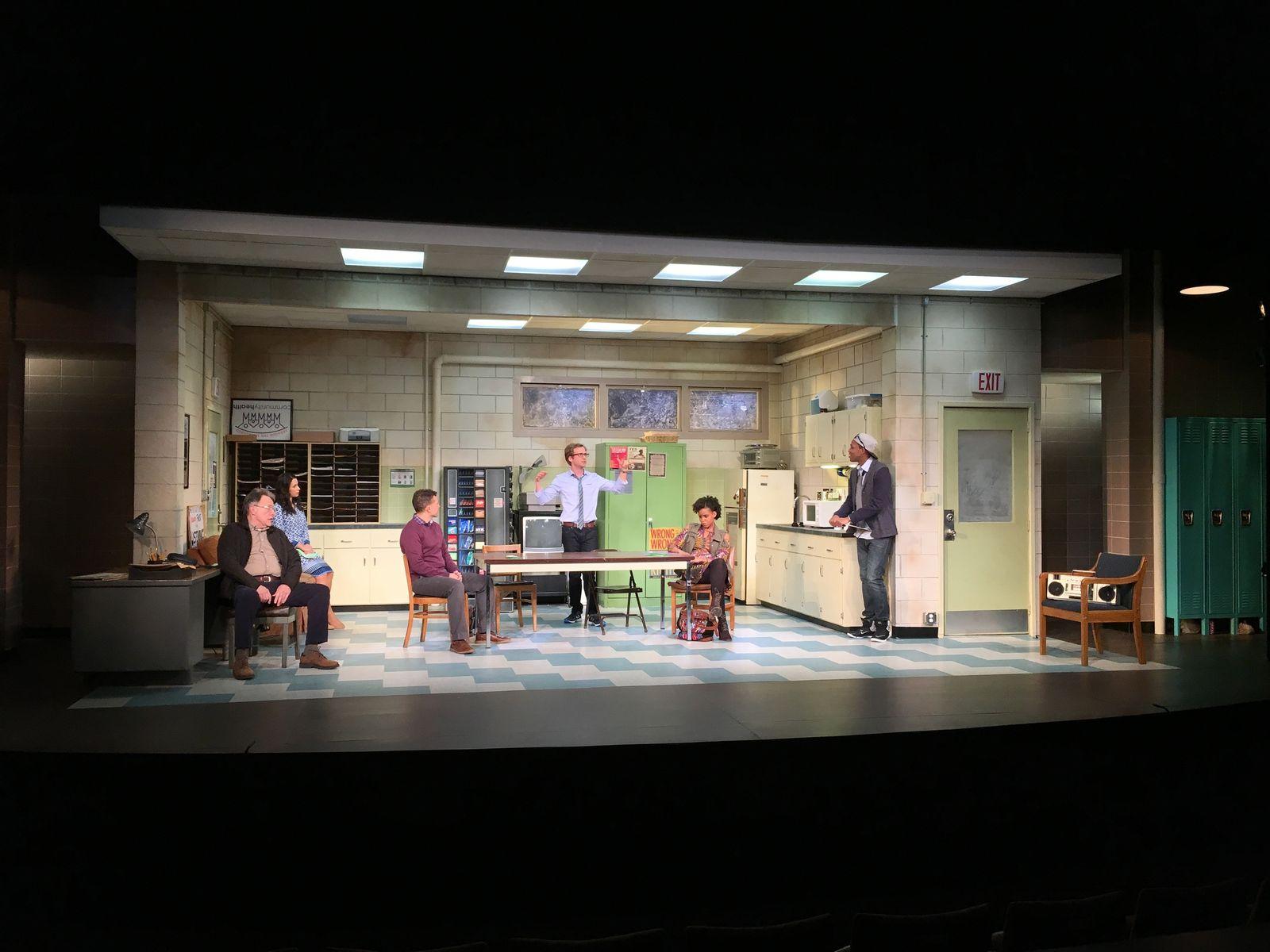 a group of people sitting around a table on a stage