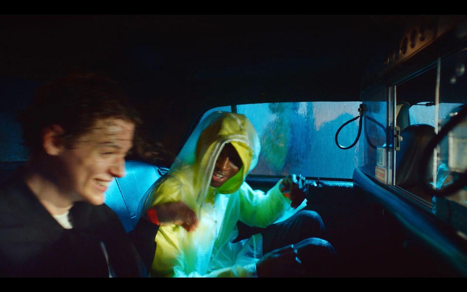 a person in a car with a hoodie on