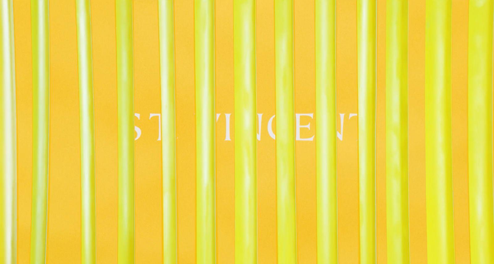 a yellow wall with white writing on it