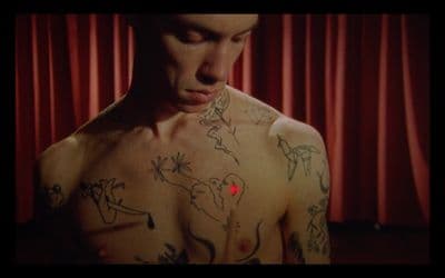 a man with a lot of tattoos on his chest