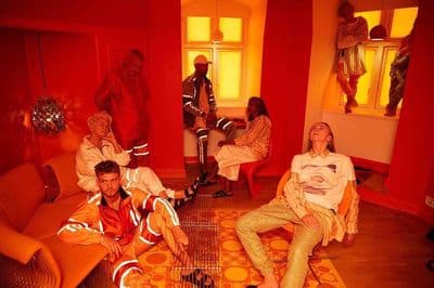 a group of people sitting around a living room