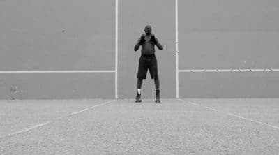 a man standing on top of a tennis court holding a racquet