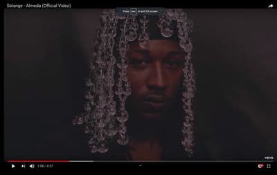 a screen shot of a man with long hair