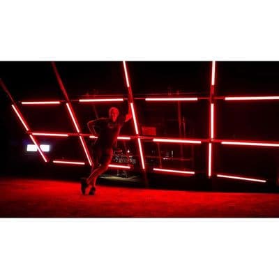 a man is dancing in front of a red light