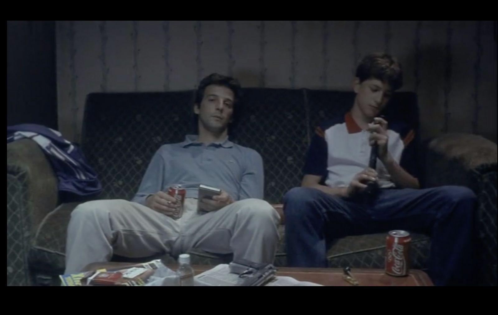 a couple of men sitting on top of a couch