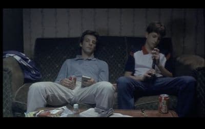 a couple of men sitting on top of a couch