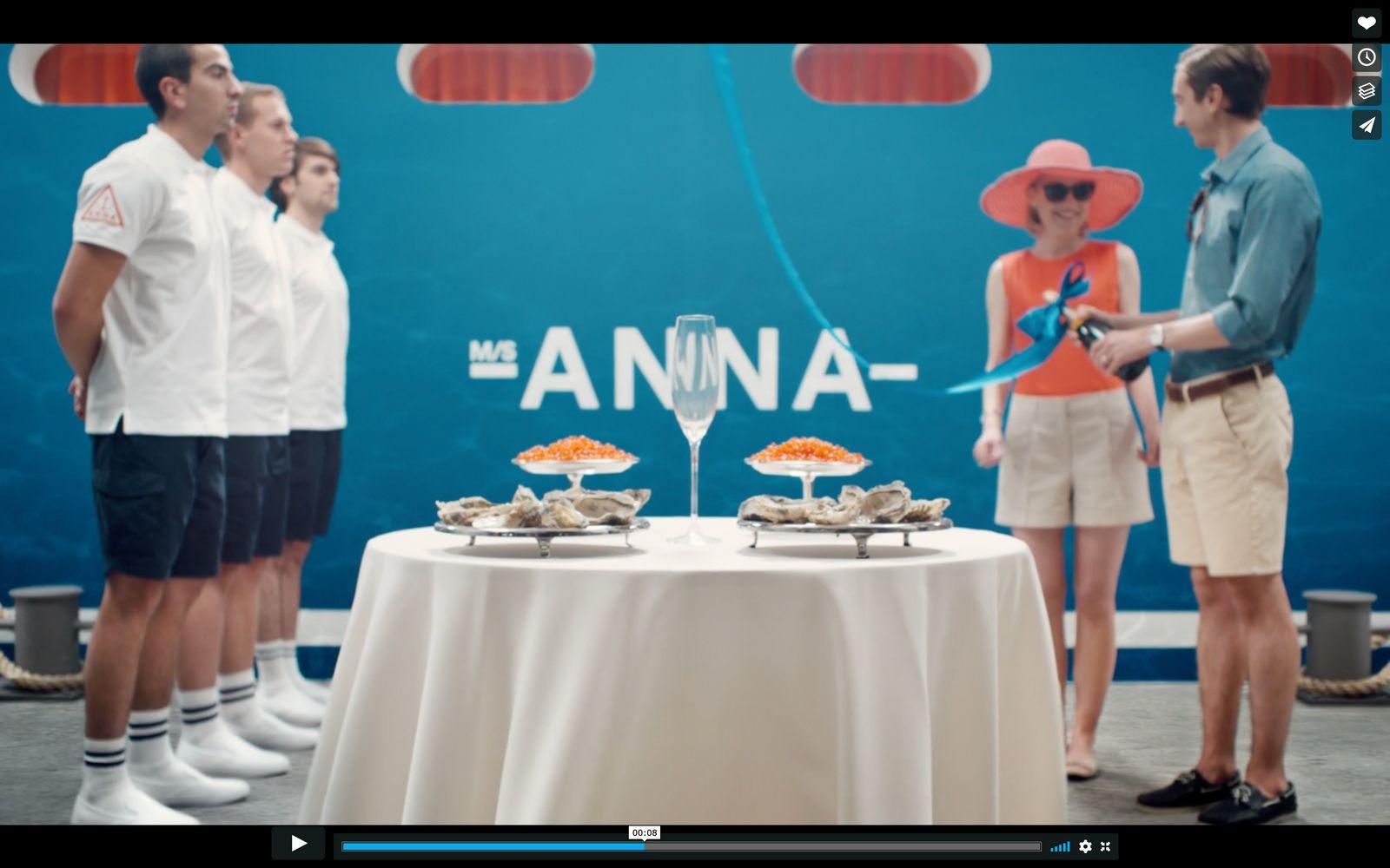 a group of people standing around a table with food on it