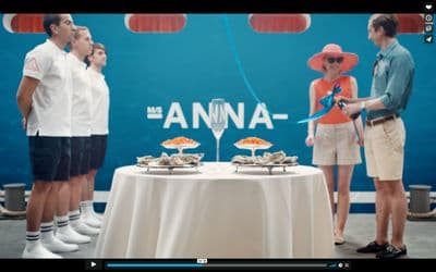 a group of people standing around a table with food on it