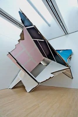 a room with a very large piece of art on the floor