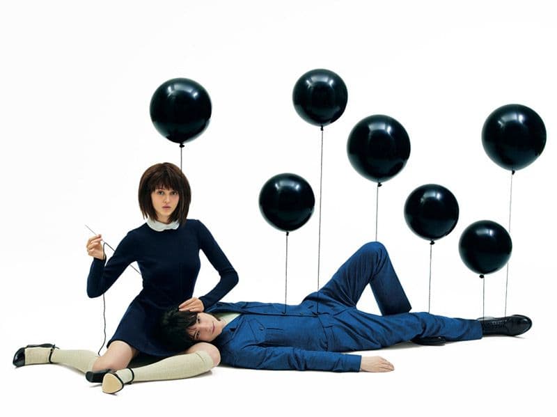 a man laying on the ground next to a woman