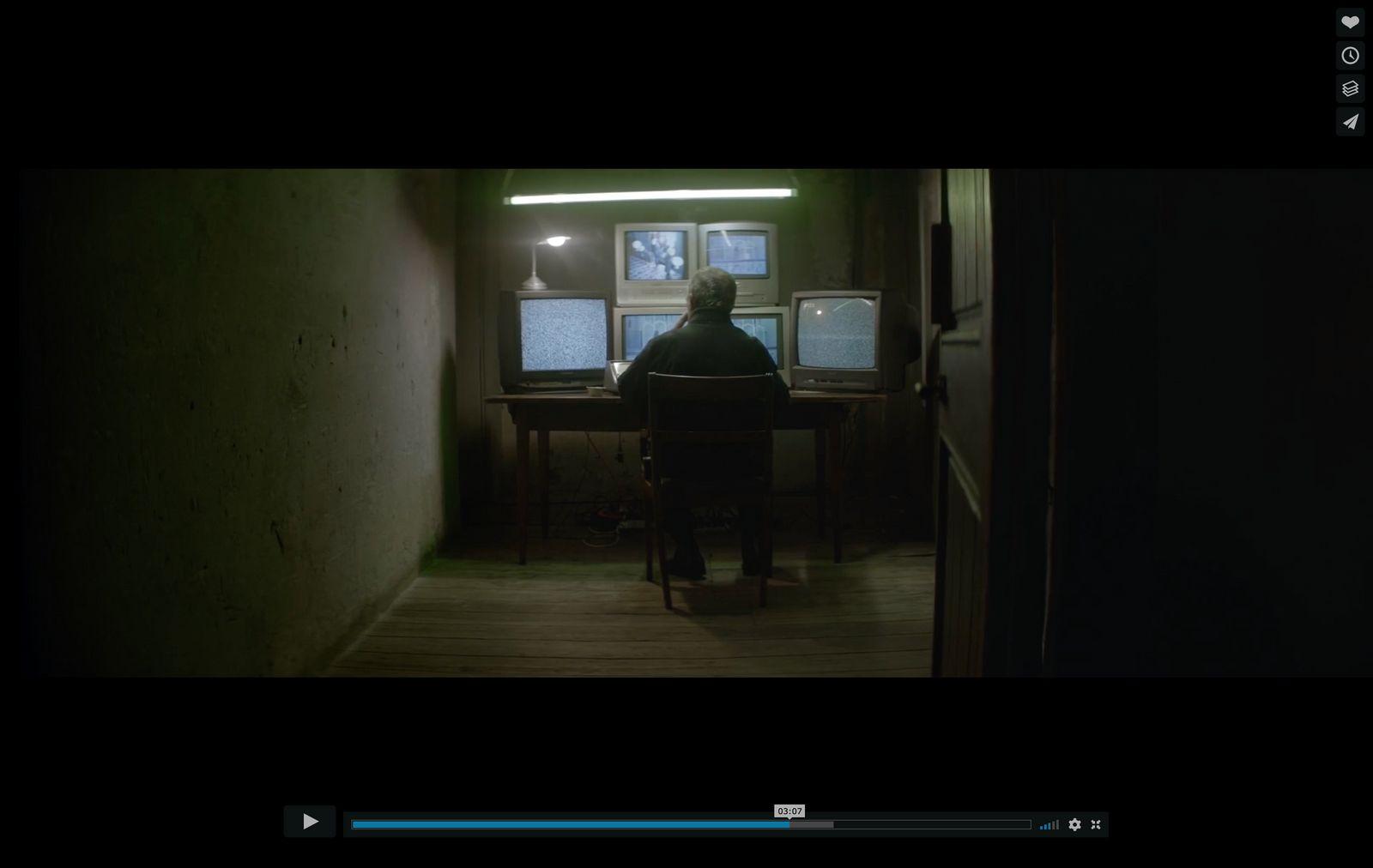 a person sitting at a desk in a dark room