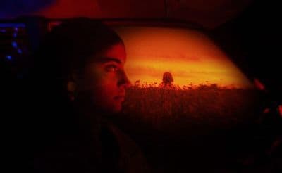 a man sitting in a car in the dark