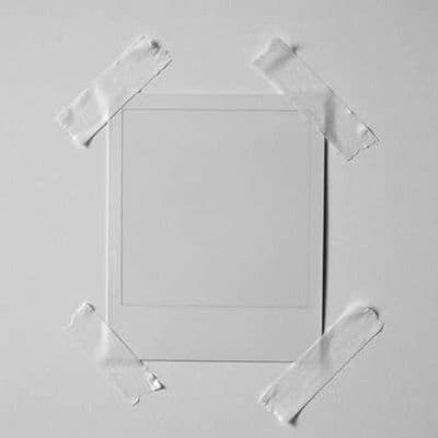 a piece of white paper taped to a white wall