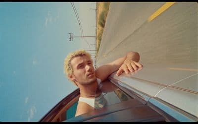 a man leaning out the window of a car