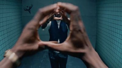 a man in a suit and tie standing in a bathroom