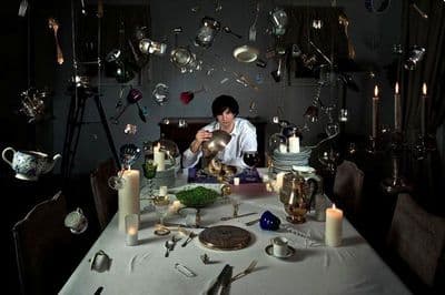 a person sitting at a table with a plate of food
