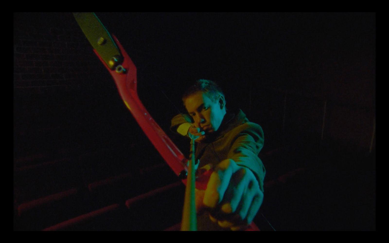 a man holding a giant pair of scissors in his hand