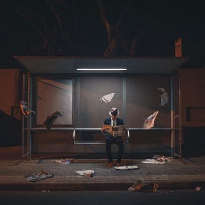 a man sitting on a bench in front of a window