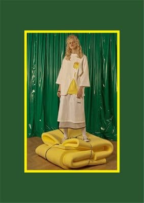 a woman standing on top of a yellow object