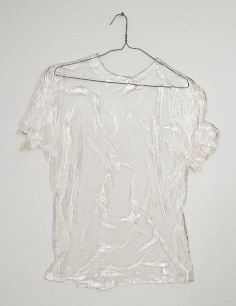 a white shirt hanging on a hanger