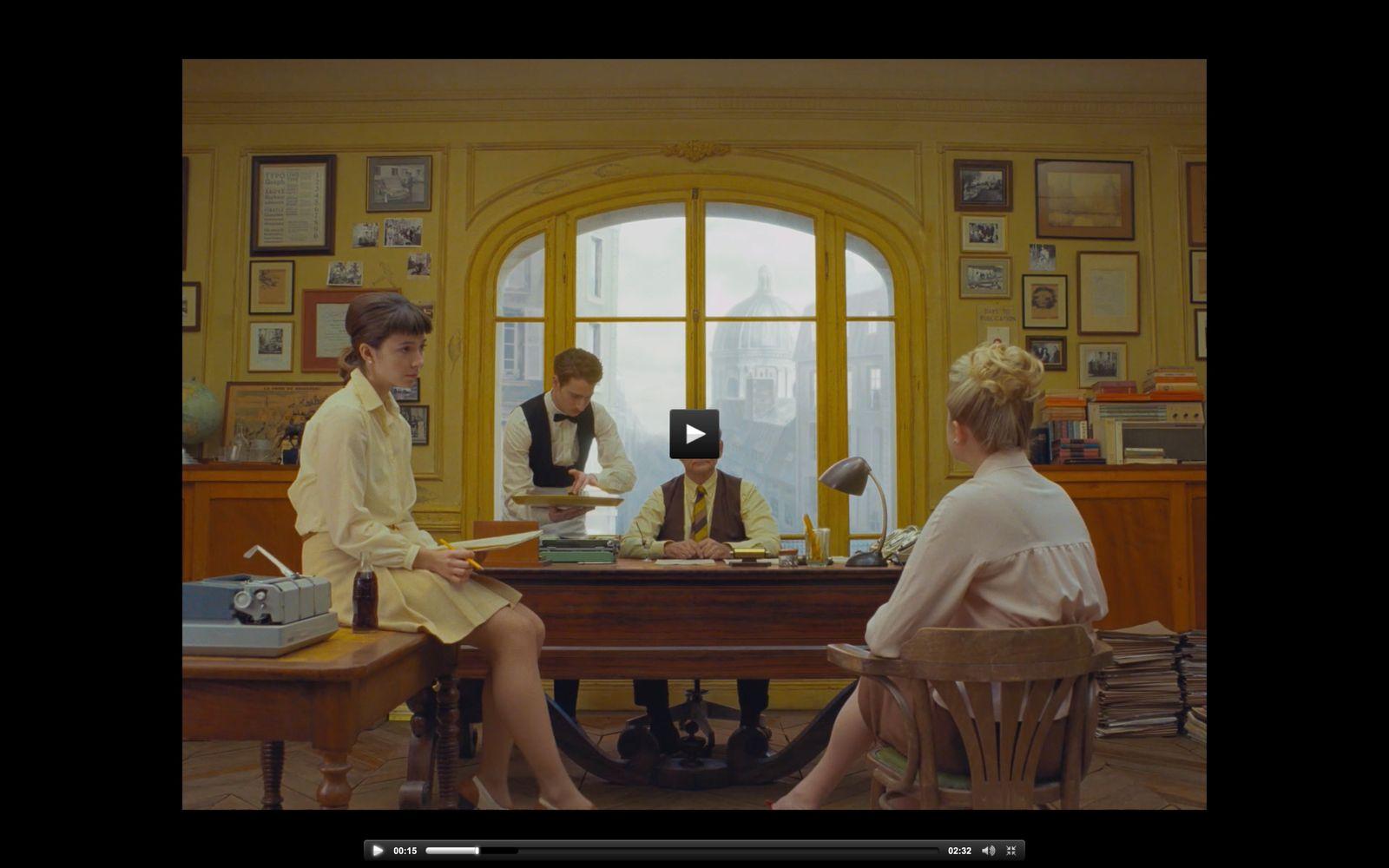 two women sitting at a table in front of a window
