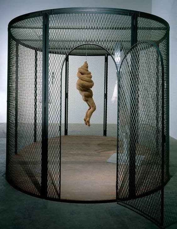 a sculpture of a woman in a caged area