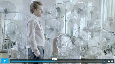 a man standing in front of a bunch of fans