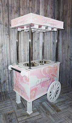 a pink and white ice cream cart on a wooden floor