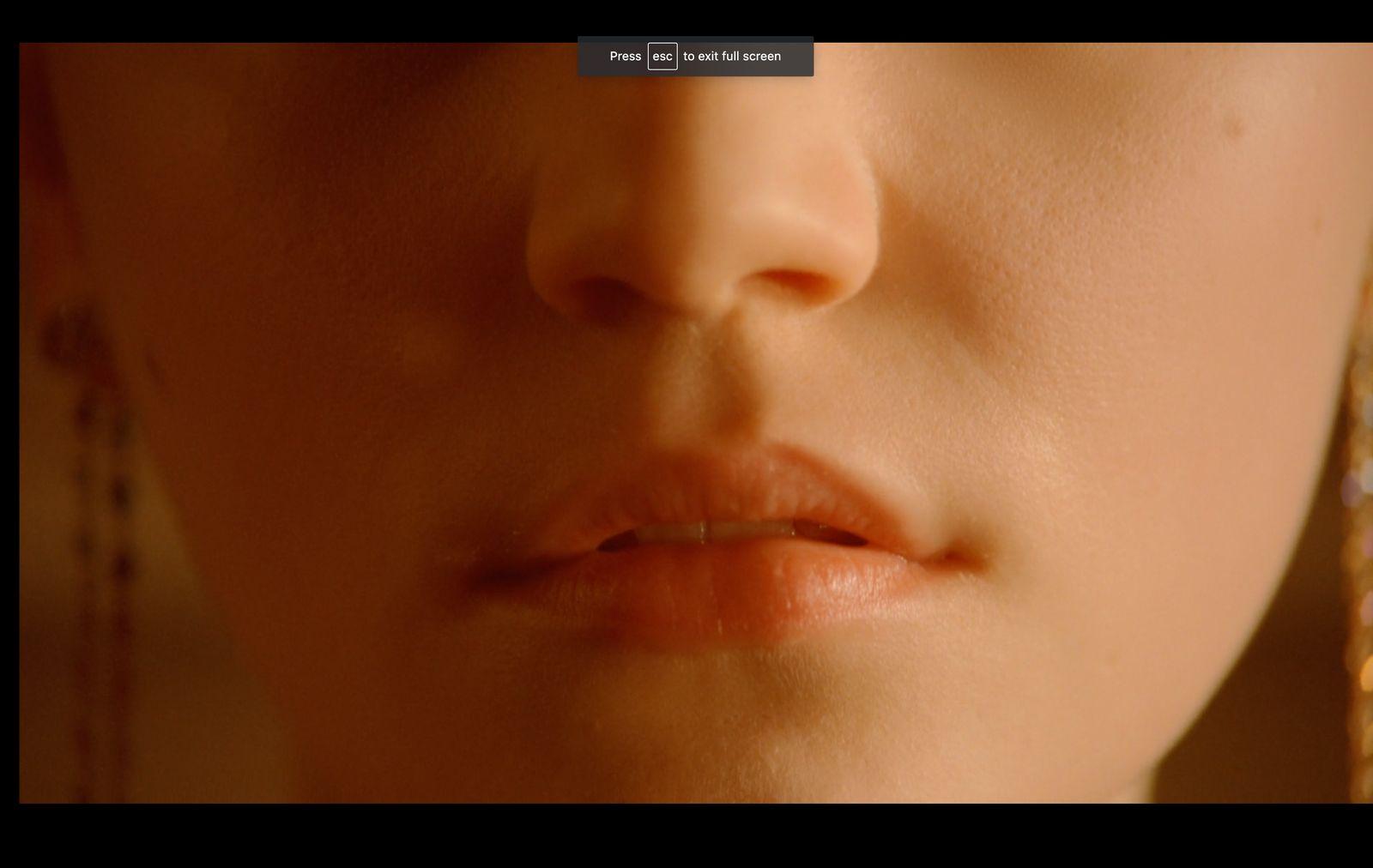 a close up of a woman's face with earrings