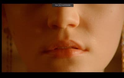 a close up of a woman's face with earrings