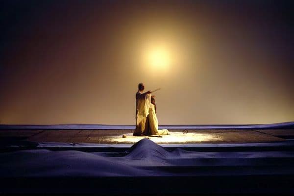 a woman standing in the snow at night
