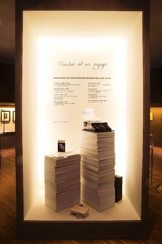 a display case filled with stacks of papers