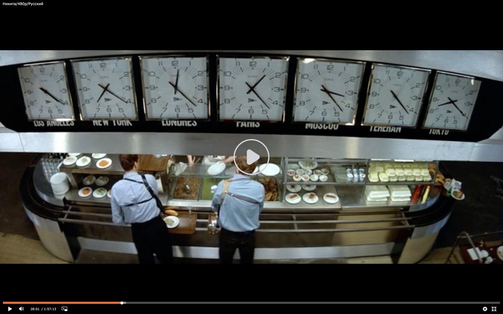 a couple of men standing in front of a counter