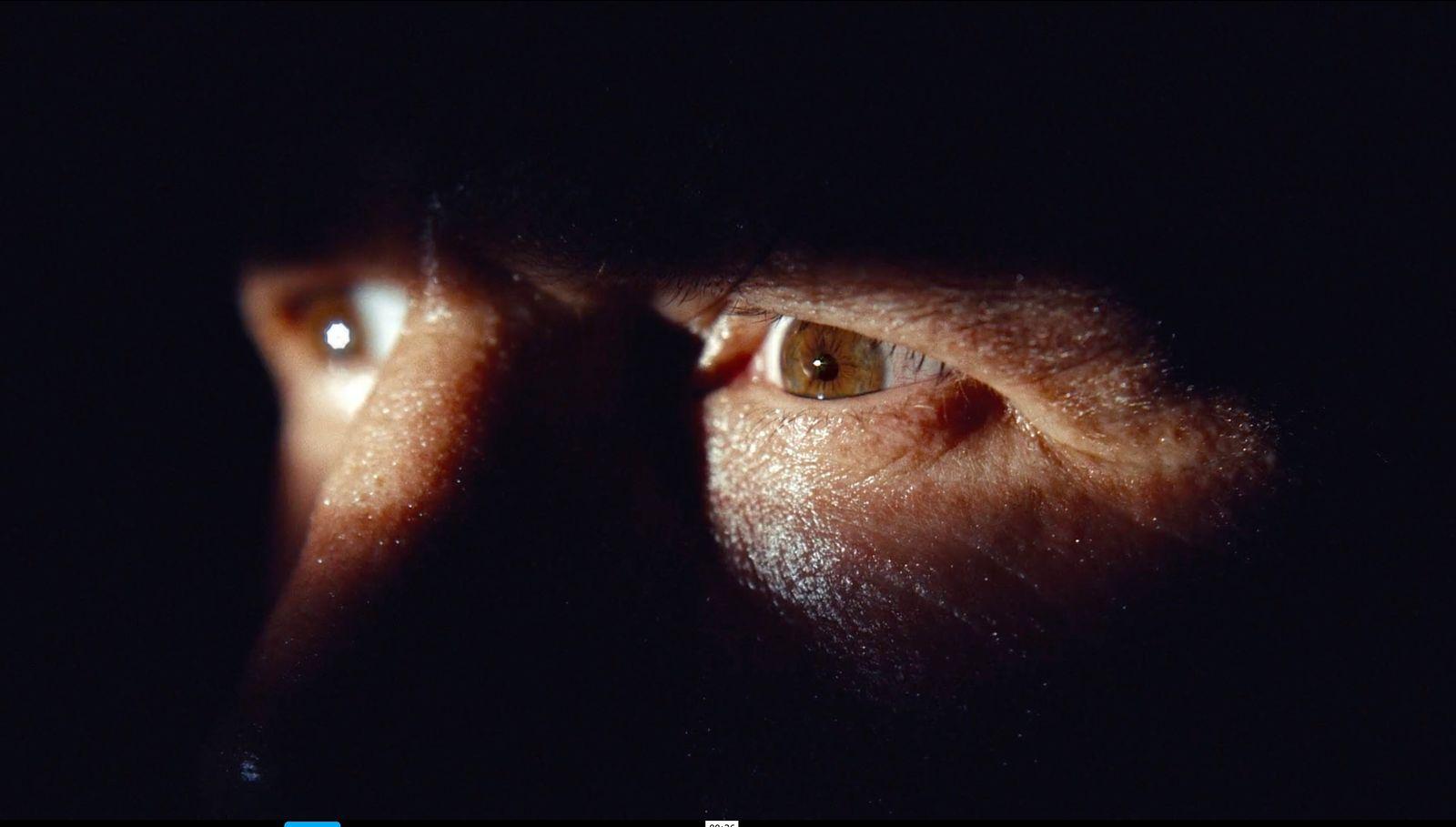 a close up of a person's face in the dark