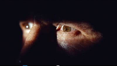 a close up of a person's face in the dark