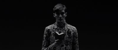 a man in a black and white photo holding a book