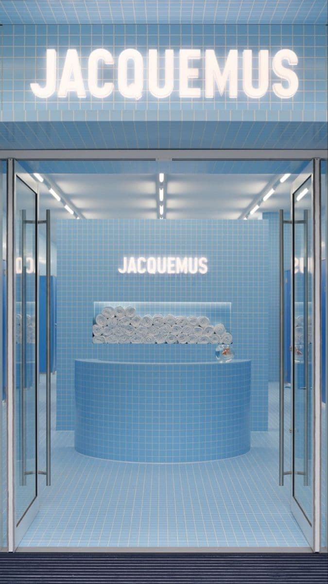 the entrance to a store with a blue tiled wall