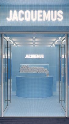 the entrance to a store with a blue tiled wall