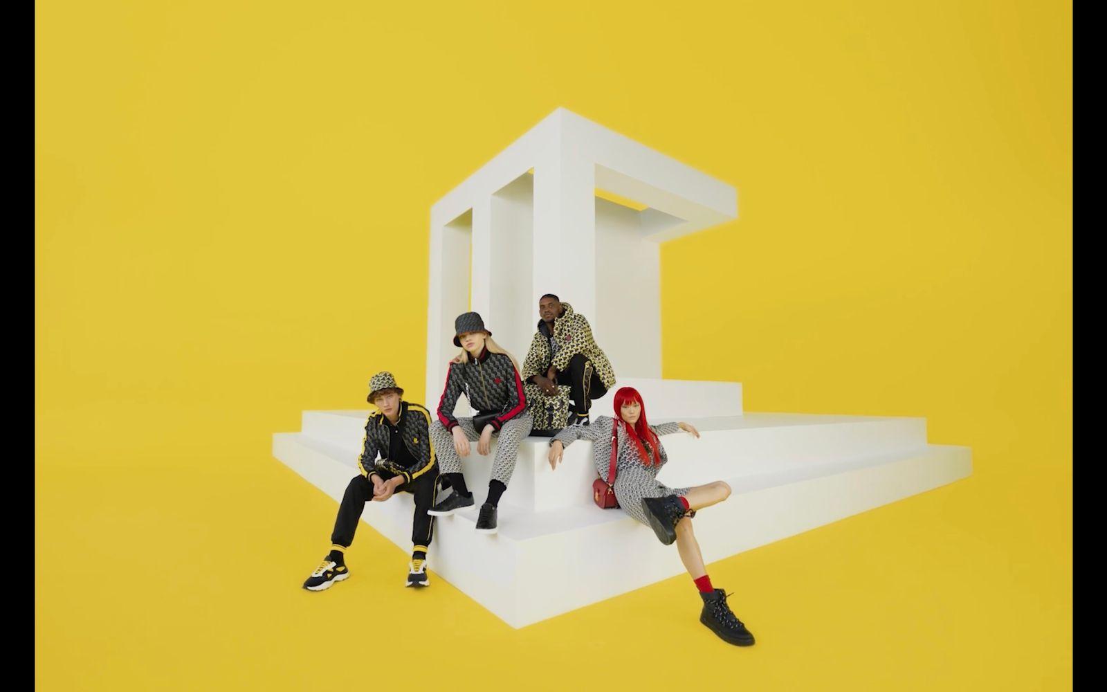 a group of people sitting on top of a white structure