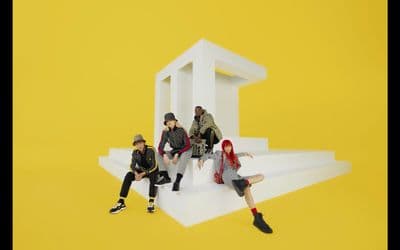 a group of people sitting on top of a white structure
