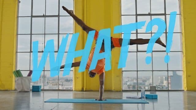a person doing a handstand in front of a window