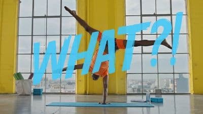 a person doing a handstand in front of a window