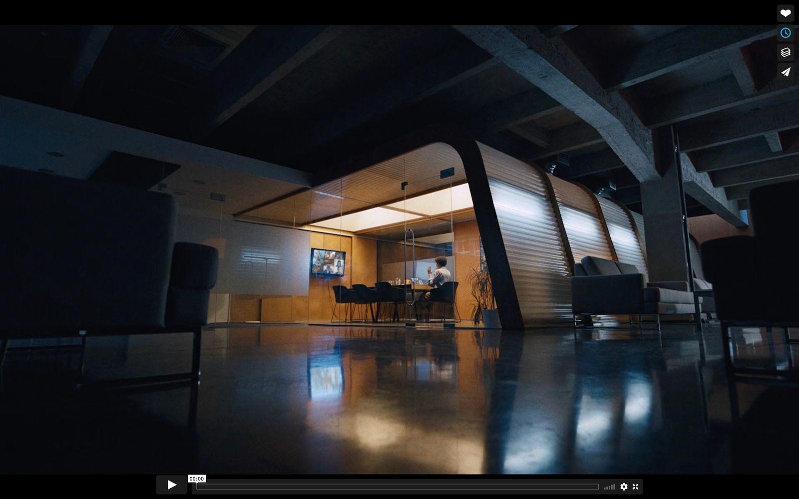 a dark room with a person sitting at a table