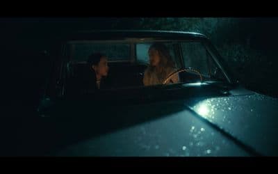two women sitting in a car in the dark