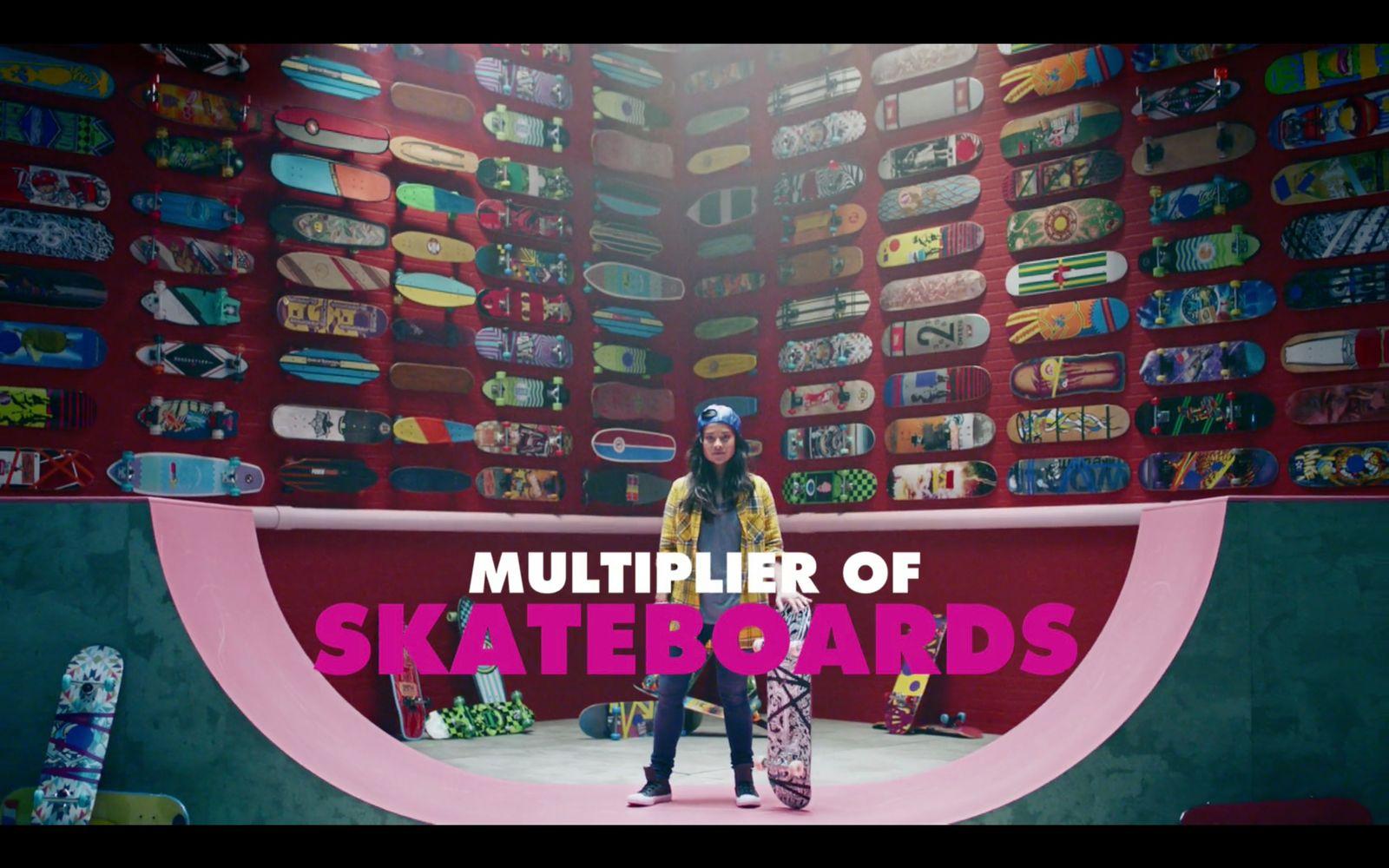 a man standing in front of a giant display of skateboards