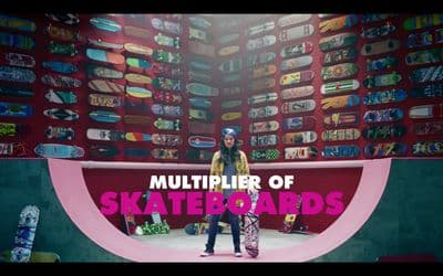 a man standing in front of a giant display of skateboards