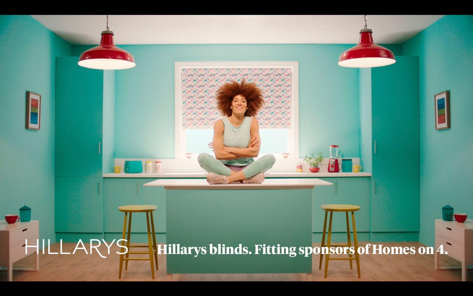 a woman sitting on top of a counter in a kitchen