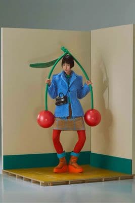 a person standing on a stage holding a pair of scissors